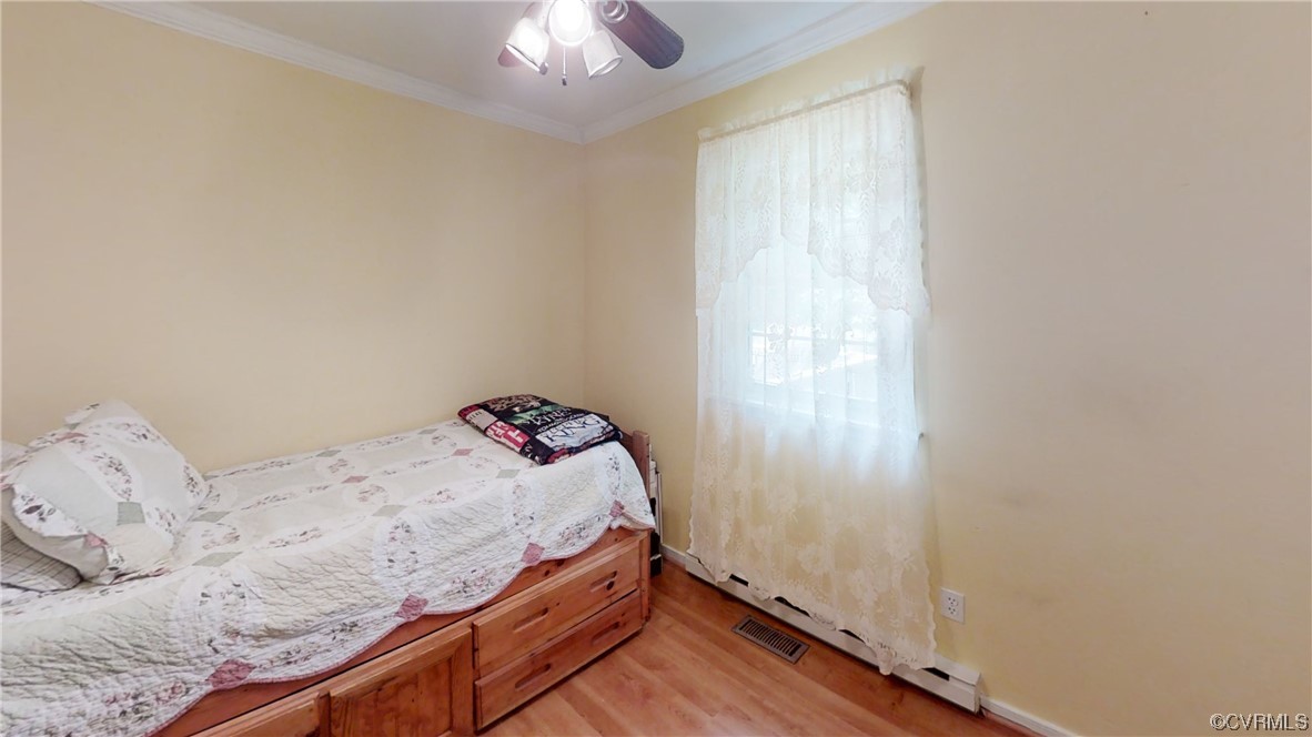 3300 Sylvania Road Chester, VA 23831 - Photo 12 of 16 a bedroom with a bed and a chandelier fan