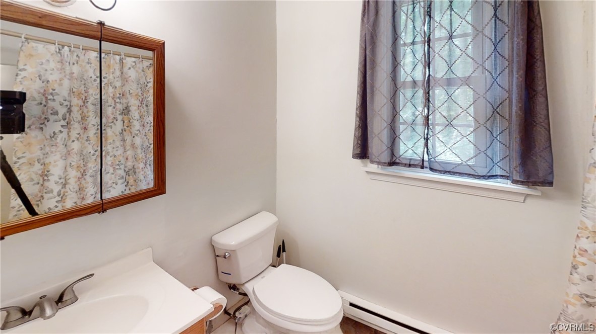 3300 Sylvania Road Chester, VA 23831 - Photo 13 of 16 a white toilet sitting next to a bathroom sink
