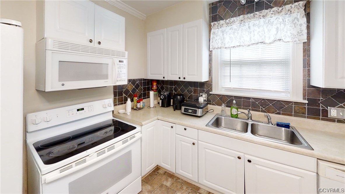 3300 Sylvania Road Chester, VA 23831 - Photo 4 of 16 a kitchen with white cabinets and white appliances