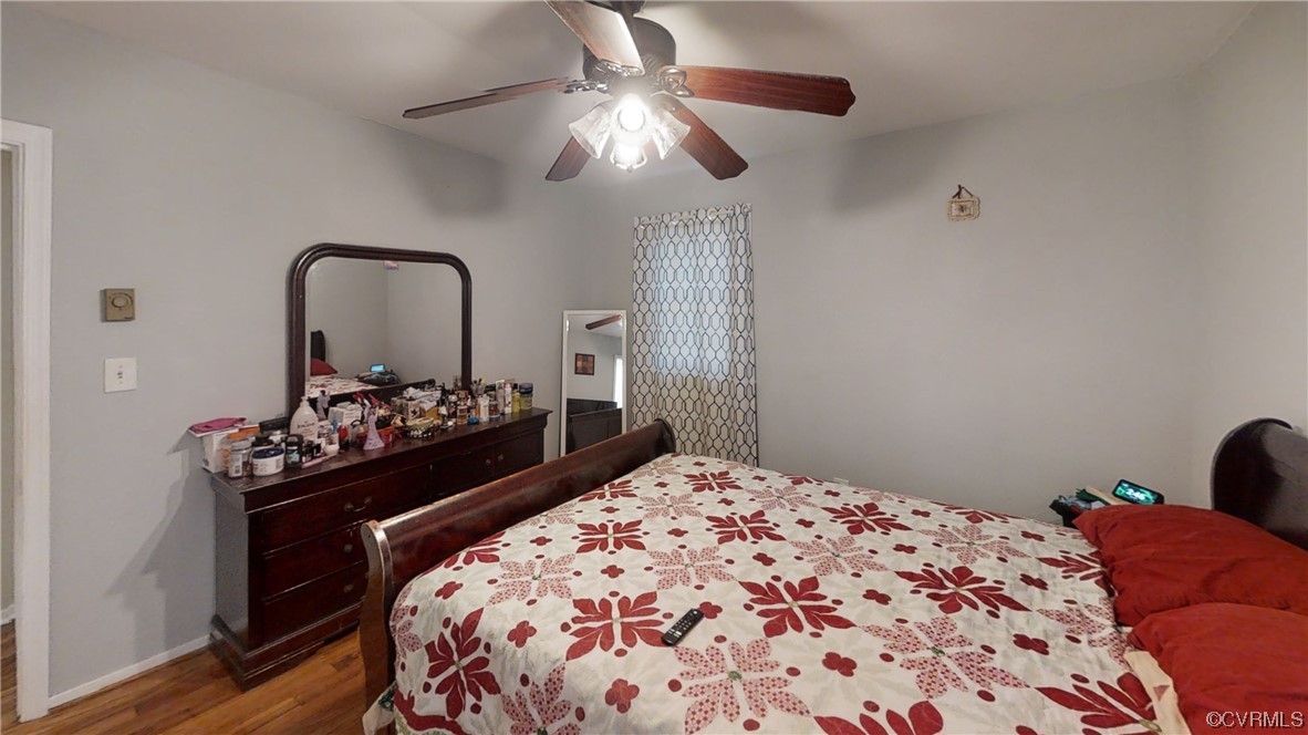 3300 Sylvania Road Chester, VA 23831 - Photo 6 of 16 a bedroom with a bed and a chandelier