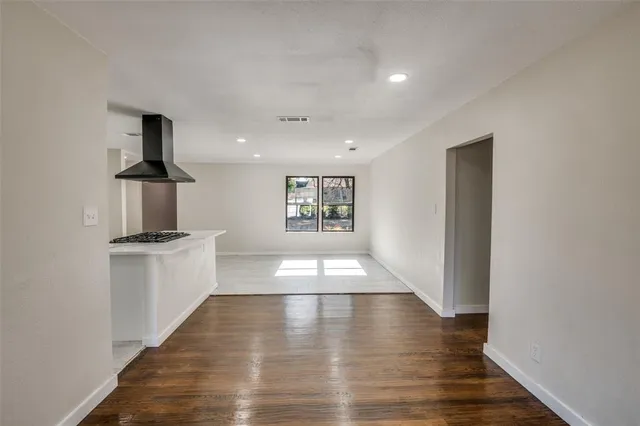 a kitchen with stainless steel appliances kitchen island granite countertop a stove and a refrigerator