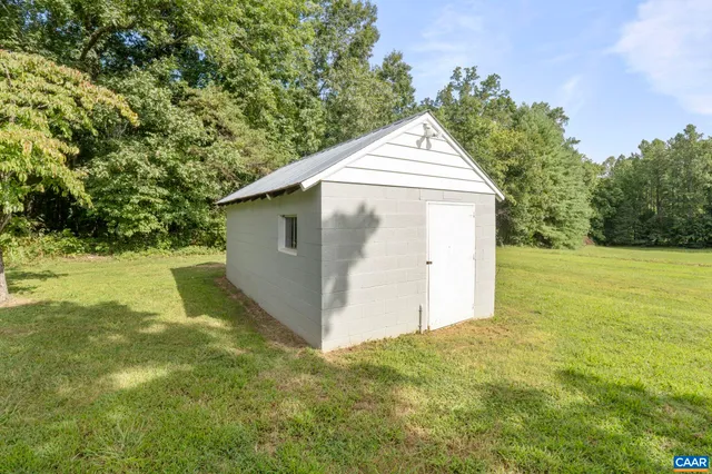 a view of a garage with a tree