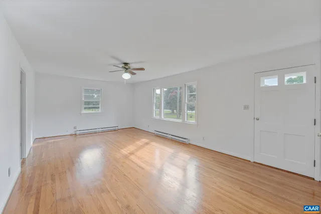 wooden floor in an empty room with a window