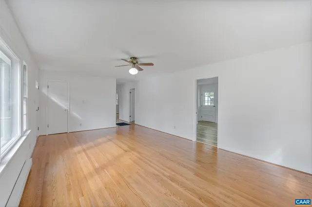 a view of an empty room with wooden floor