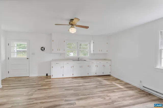a view of a kitchen with a microwave and cabinets