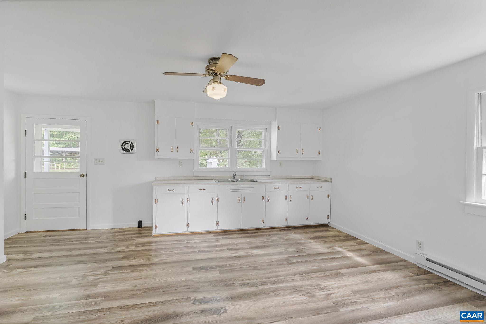 12395 South Constitution Route Scottsville, VA 24590 - Photo 7 of 37 a view of a kitchen with a microwave and cabinets