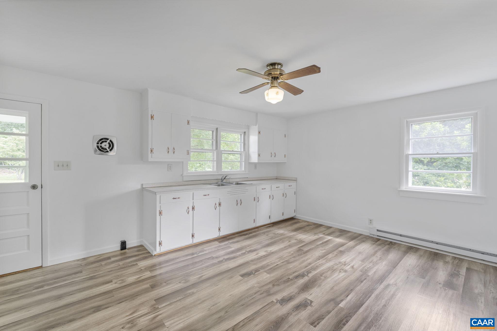 12395 South Constitution Route Scottsville, VA 24590 - Photo 8 of 37 a view of empty room with wooden floor and window
