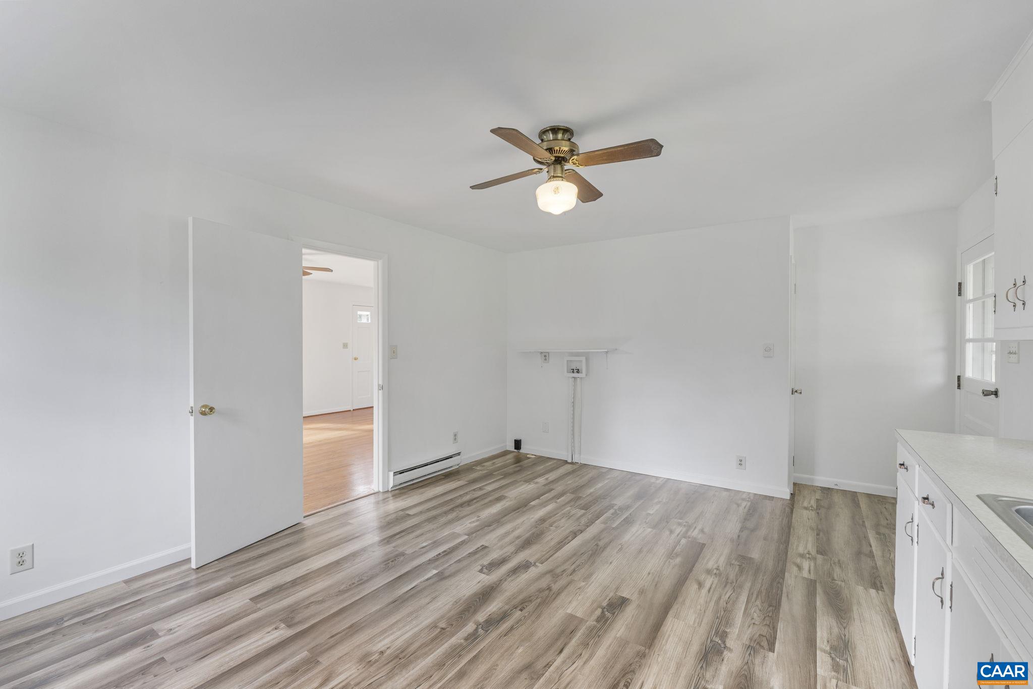 12395 South Constitution Route Scottsville, VA 24590 - Photo 10 of 37 a view of empty room with wooden floor and ceiling fan