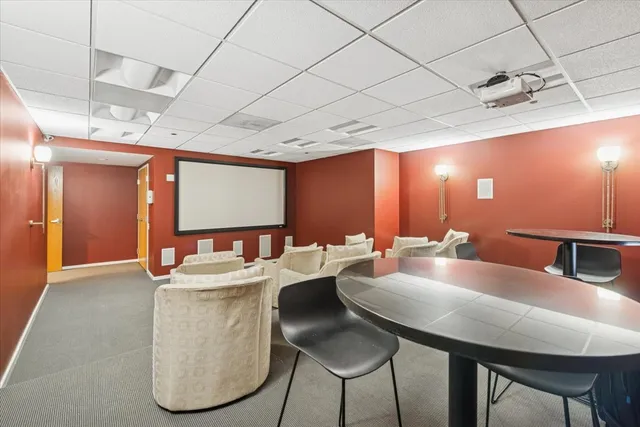 a dining hall with stainless steel appliances kitchen island a table and chairs