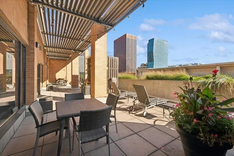 a view of a chairs and table in patio with potted plants