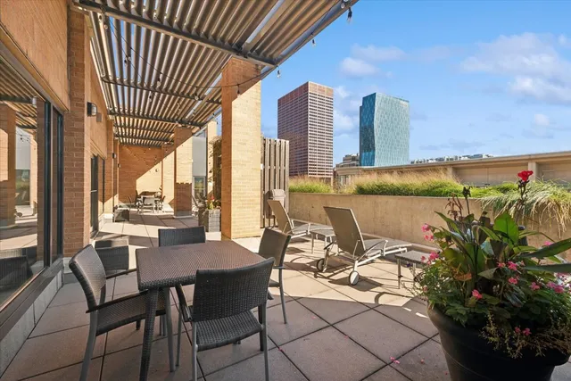 a view of a chairs and table in patio with potted plants