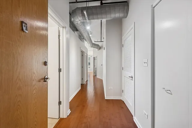 a view of a hallway with wooden floor