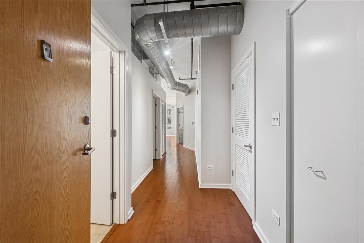 520 South State Street, Unit 907 Chicago, IL 60605 - Photo 3 of 26 a view of a hallway with wooden floor