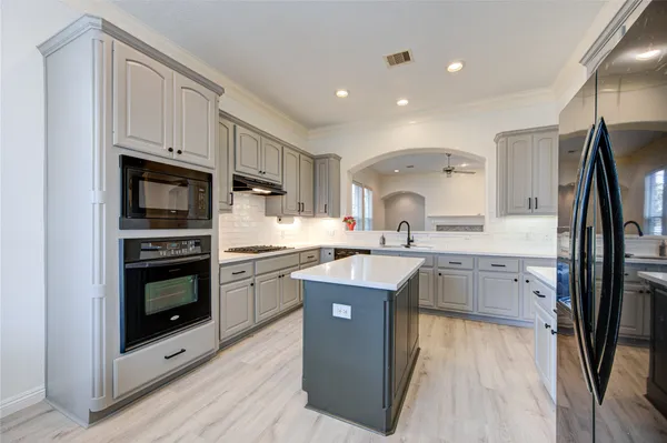 a kitchen with a sink stainless steel appliances and cabinets