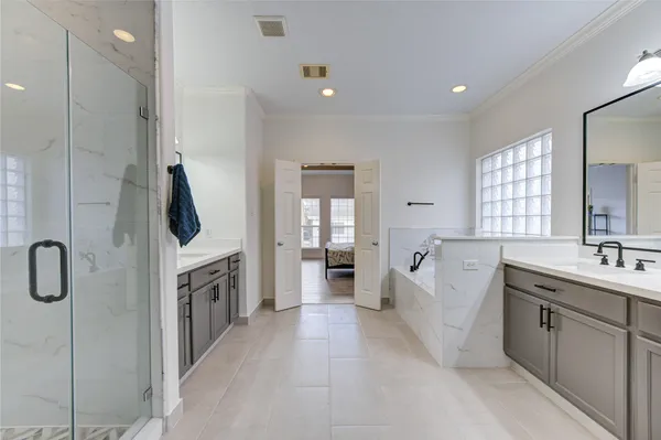 a bathroom with a double vanity sink a mirror and shower