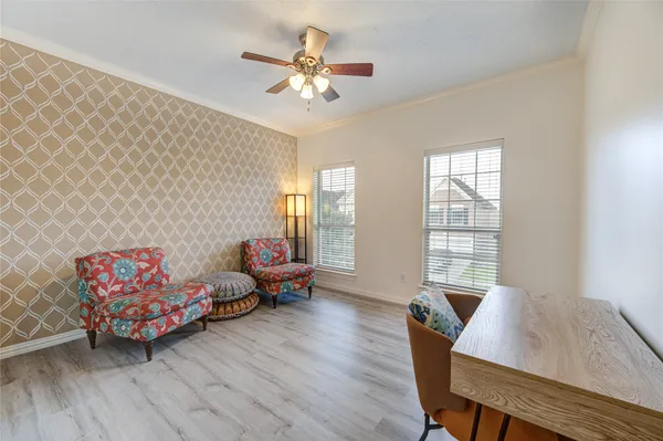 a living room with furniture and two window