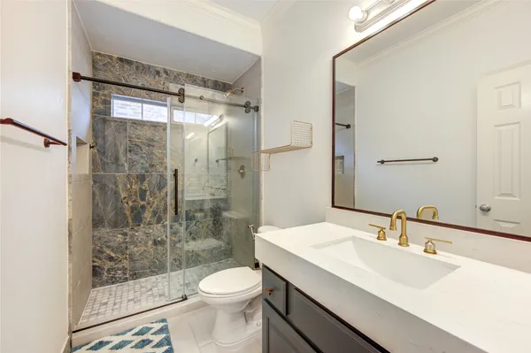 a bathroom with a sink toilet and shower