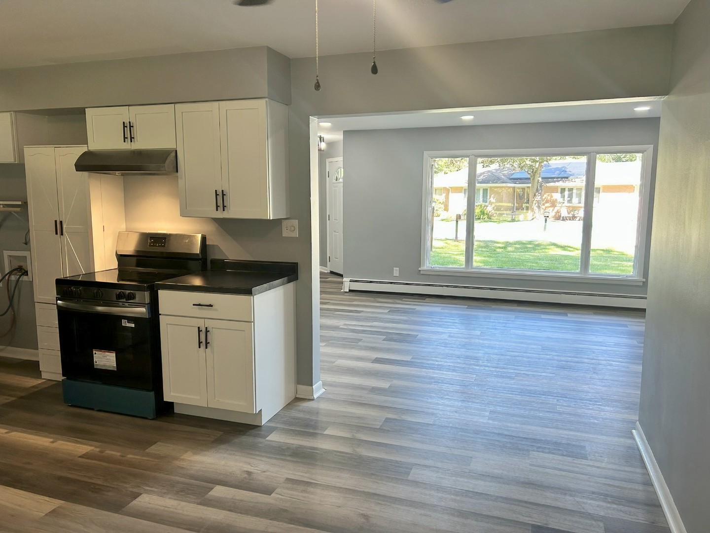 55 Cherry Drive Kankakee, IL 60901 - Photo 11 of 42 a kitchen with granite countertop a stove and a wooden floor