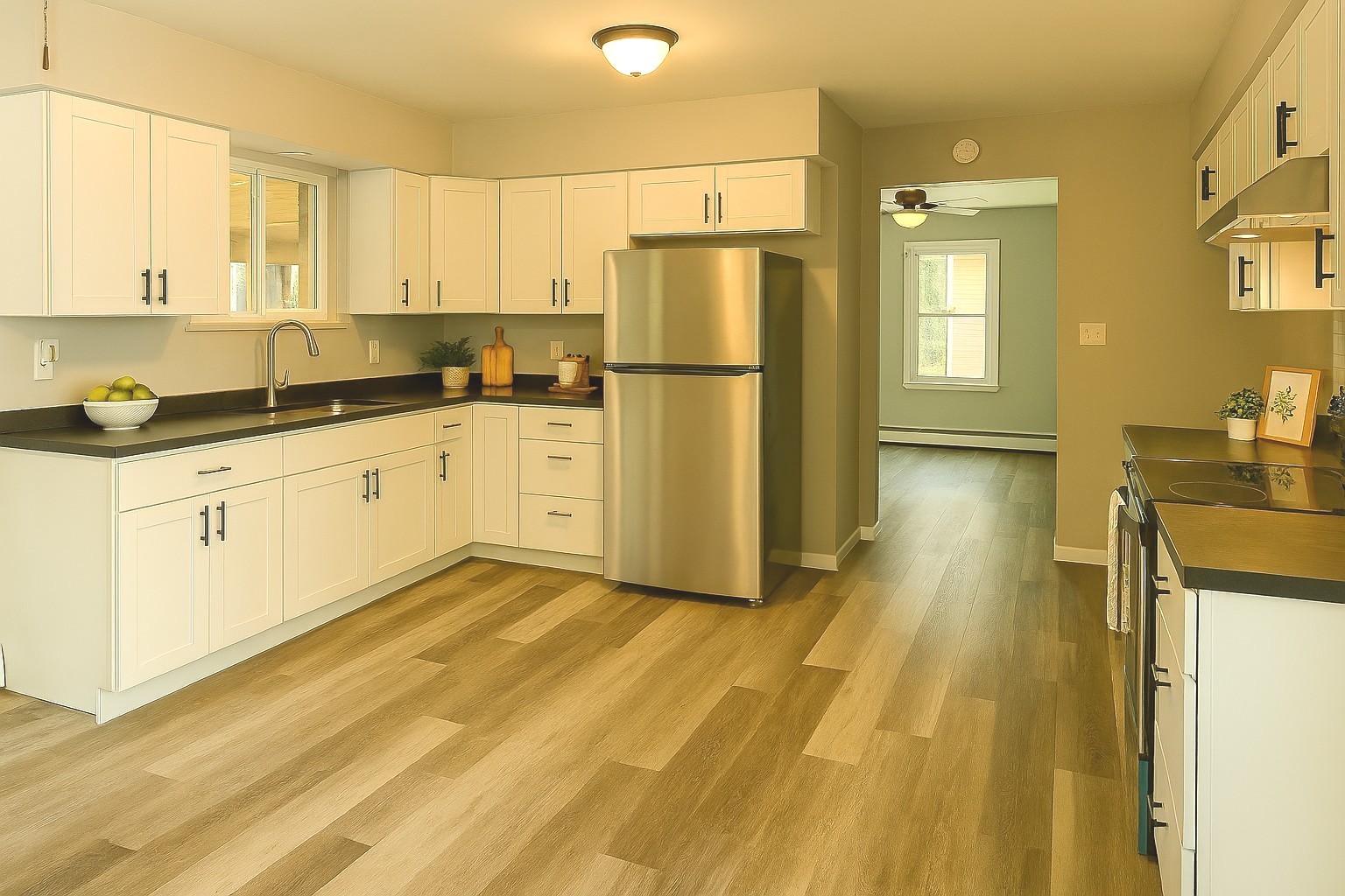 55 Cherry Drive Kankakee, IL 60901 - Photo 14 of 42 a kitchen with stainless steel appliances granite countertop a refrigerator a stove and white cabinets with wooden floor