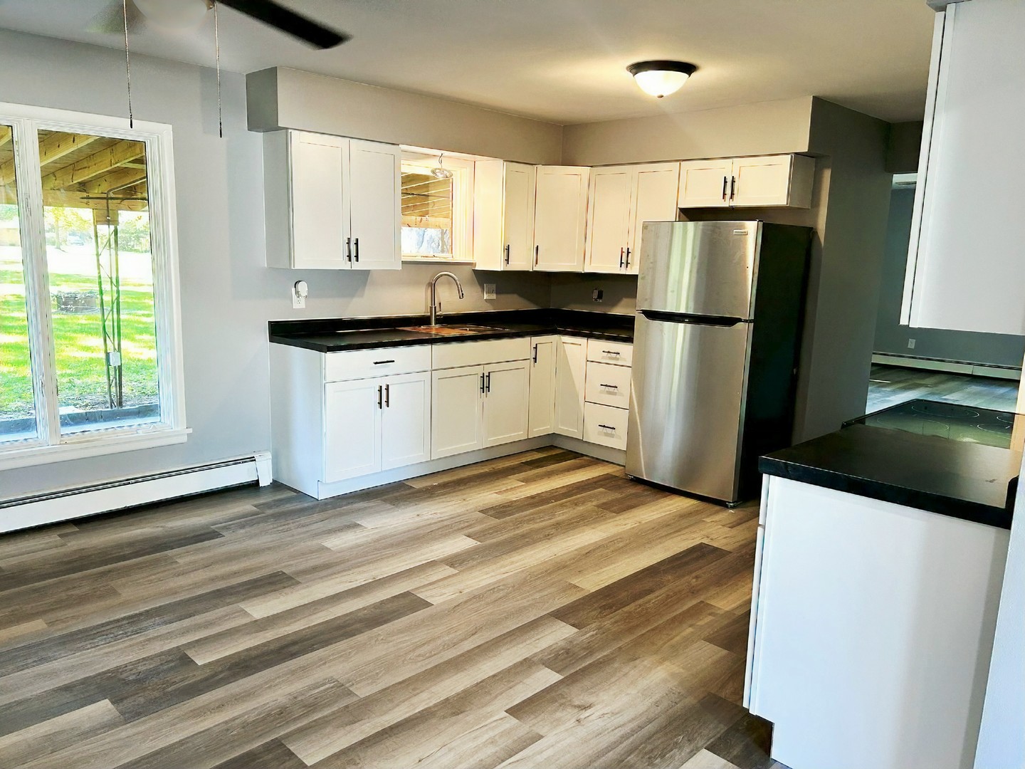 55 Cherry Drive Kankakee, IL 60901 - Photo 15 of 42 a kitchen with a refrigerator sink and cabinets