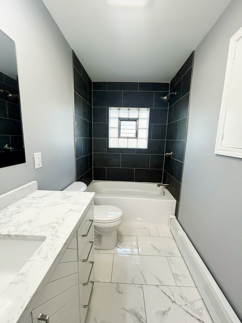 55 Cherry Drive Kankakee, IL 60901 - Photo 20 of 42 a bathroom with a sink a toilet and shower