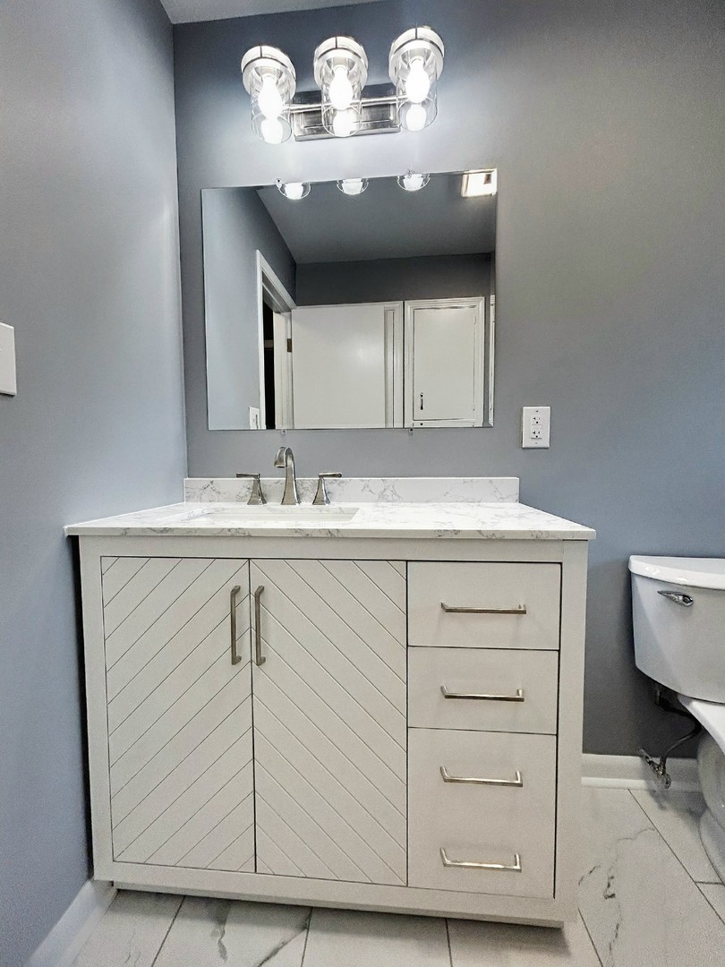 55 Cherry Drive Kankakee, IL 60901 - Photo 22 of 42 a bathroom with a sink and a mirror