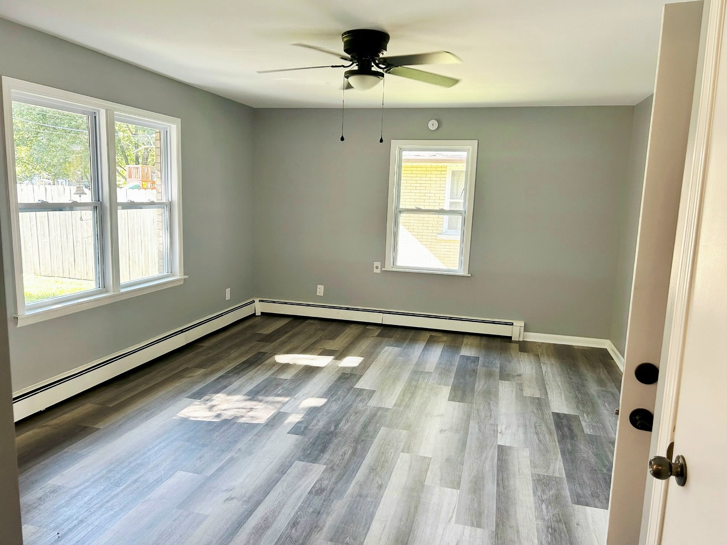 55 Cherry Drive Kankakee, IL 60901 - Photo 24 of 42 a view of an empty room with a window and wooden floor