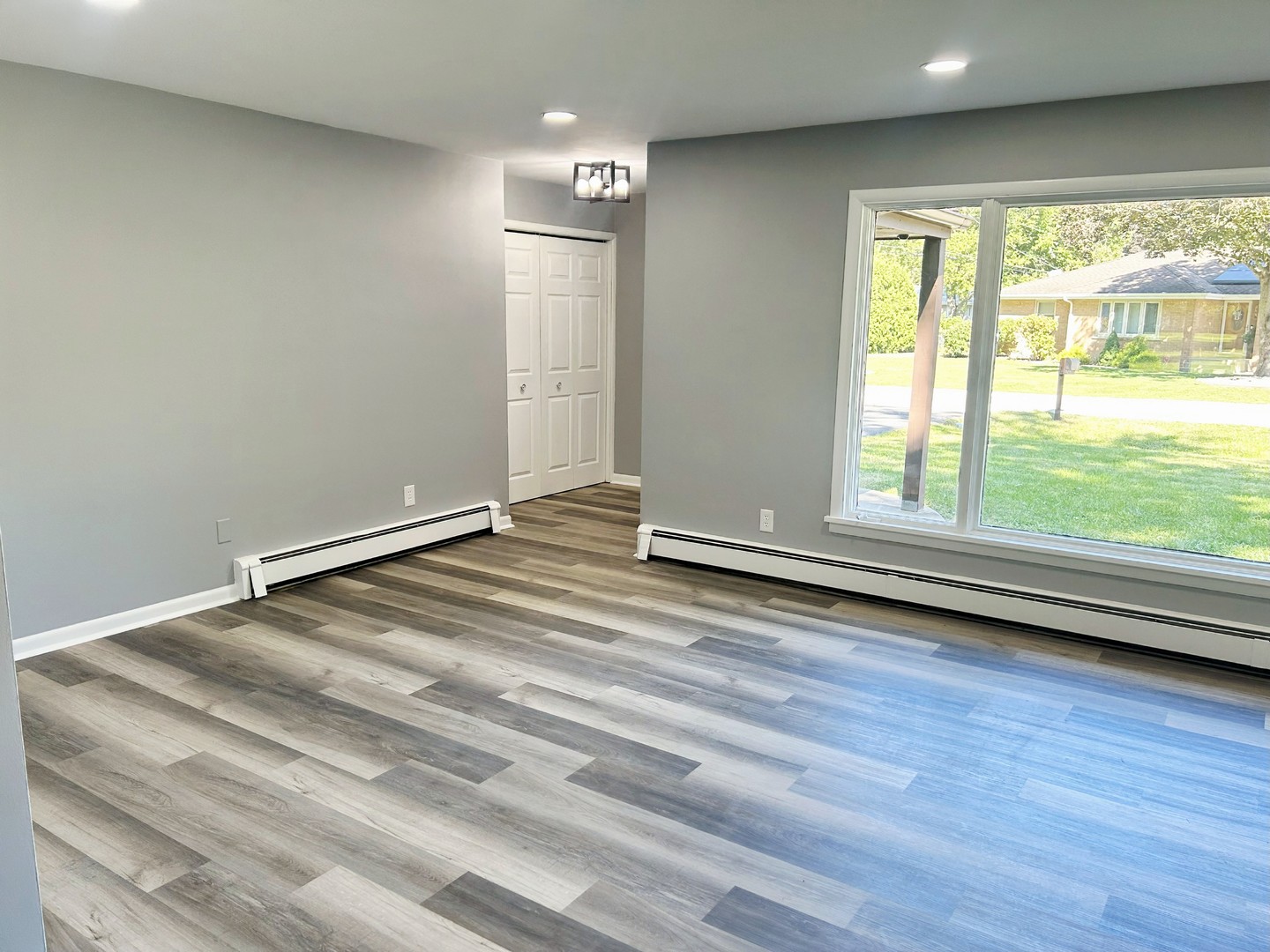 55 Cherry Drive Kankakee, IL 60901 - Photo 7 of 42 an empty room with wooden floor and windows