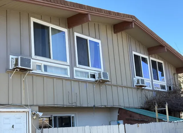 a view of a house with wooden fence