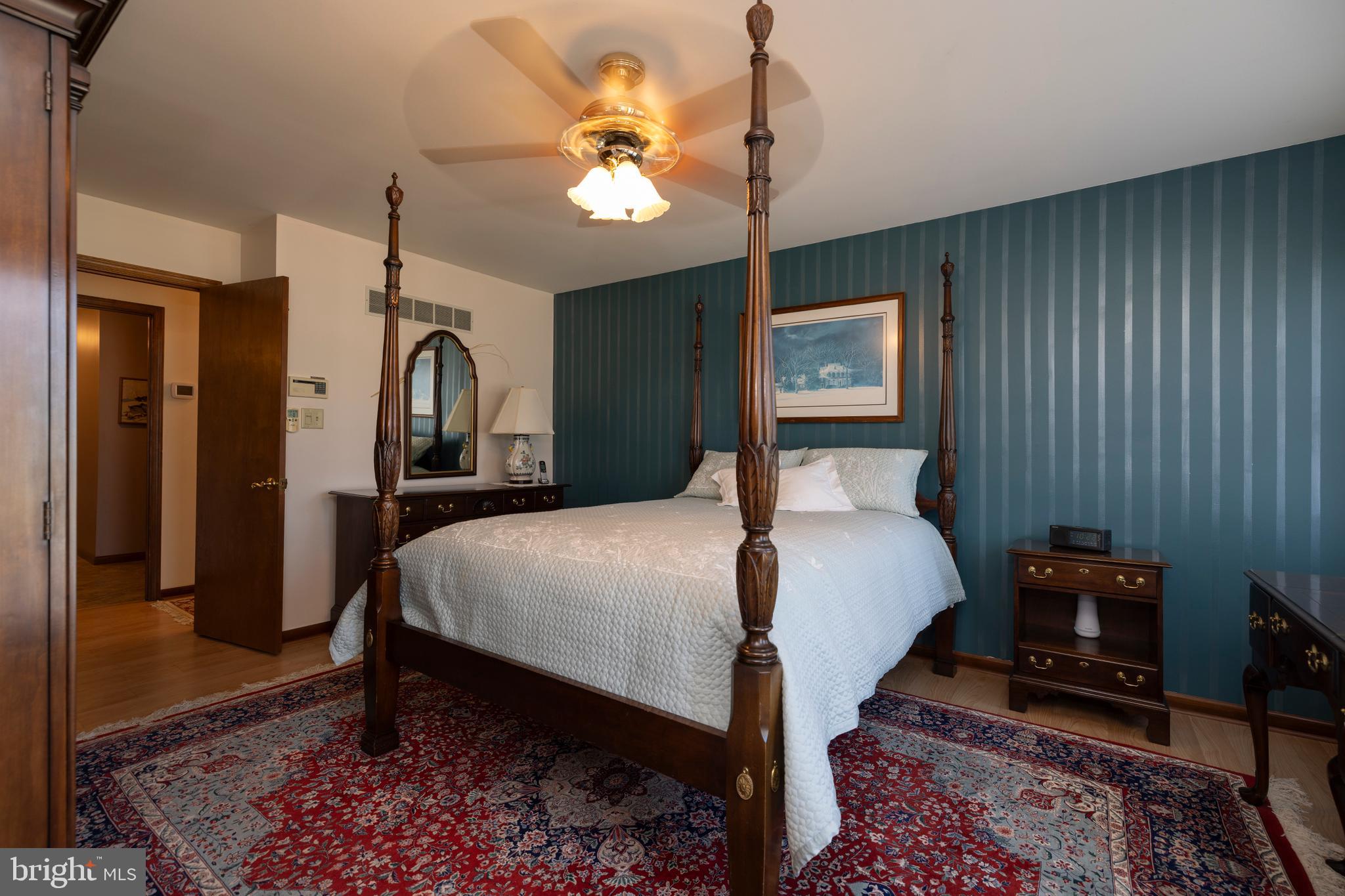 4043 Blue Ball Road Elkton, MD 21921 - Photo 26 of 54 a bedroom with a bed dresser and wooden floor