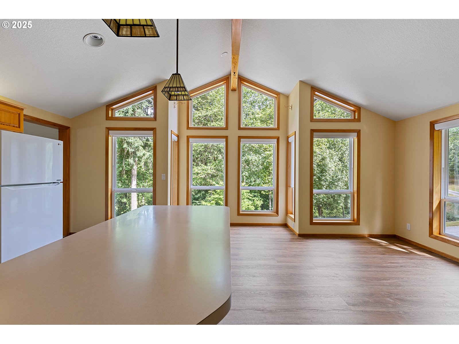 6411 Northwest 291st Street Ridgefield, WA 98642 - Photo 5 of 40 a view of an empty room with wooden floor and a window