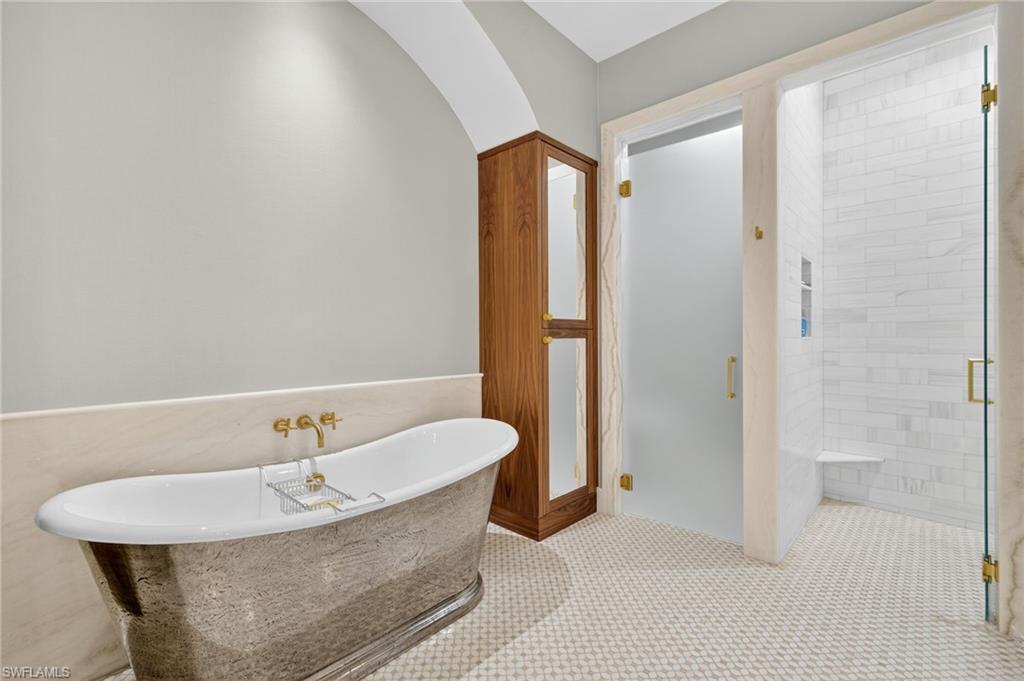 111 Caribbean Road Naples, FL 34108 - Photo 24 of 50 a bathroom with a bathtub and a sink