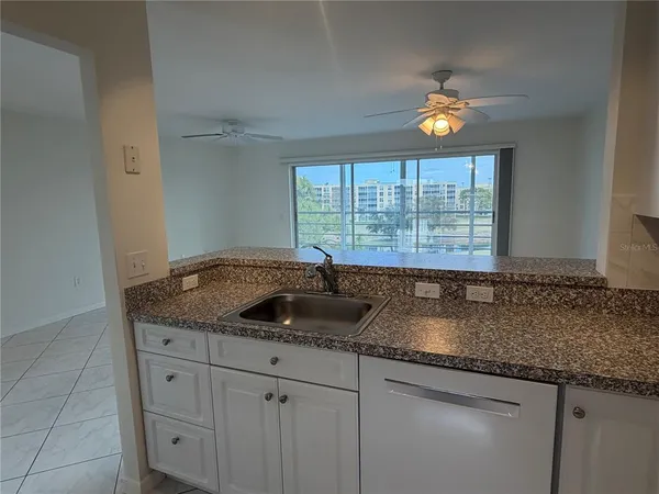 a kitchen with granite countertop a sink and a window