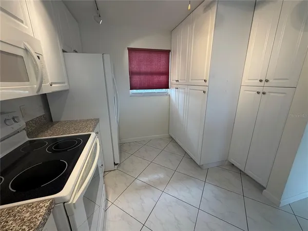 a kitchen with cabinets and a stove top oven