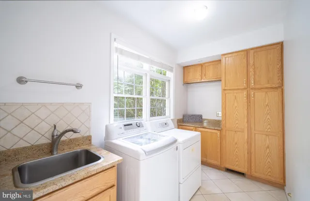 a bathroom with a granite countertop toilet and a sink