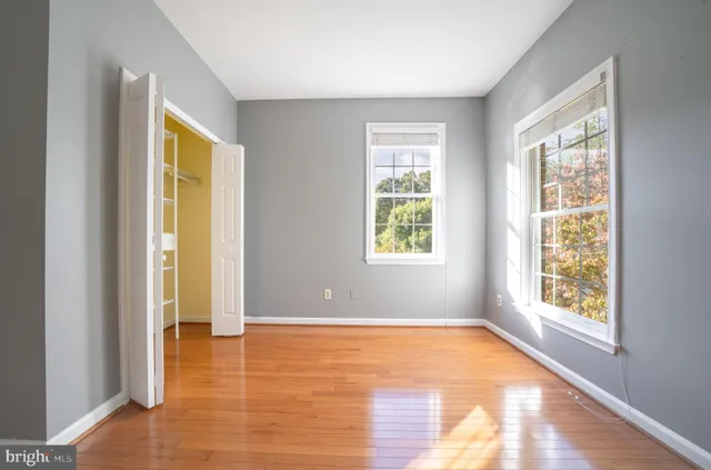 a bathroom with a granite countertop sink a mirror and a bathtub