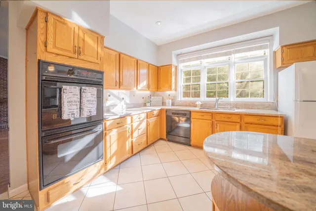 a view of a kitchen with a sink and cabinets