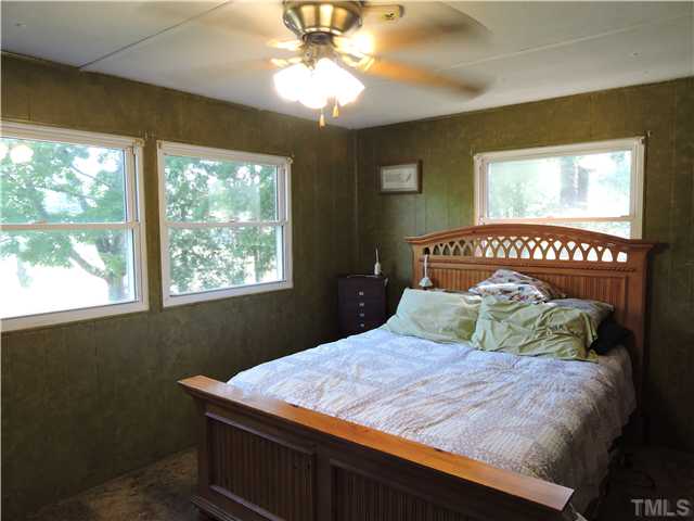 4892 Boston Road Roxboro, NC 27574 - Photo 6 of 11 a bedroom with a bed and a window