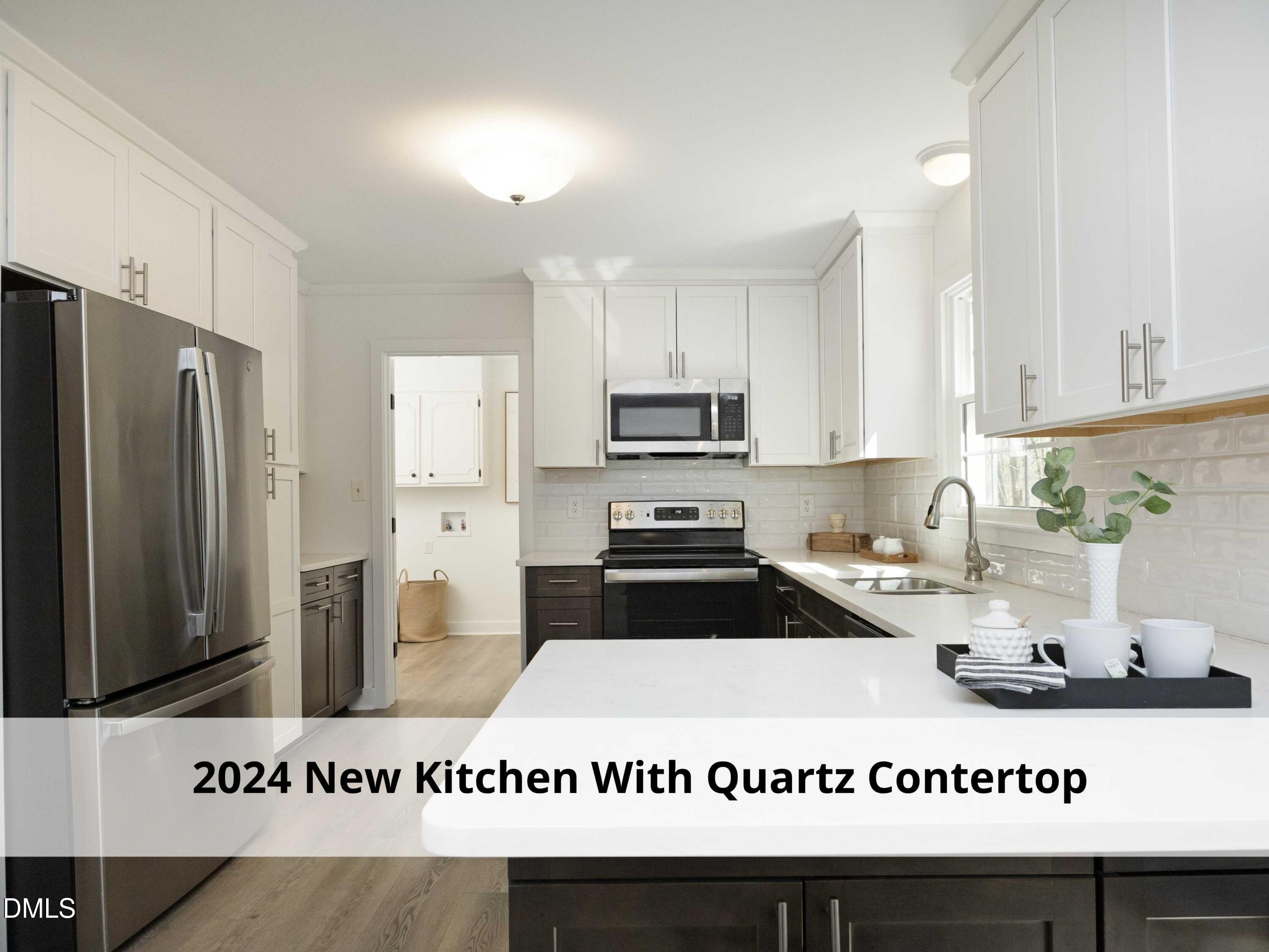 1409 Cotherstone Drive Durham, NC 27712 - Photo 24 of 61 a kitchen with a refrigerator a stove a sink a counter space and cabinets