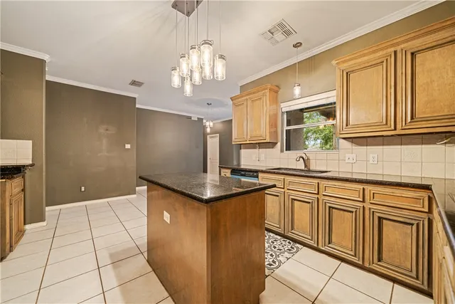 a view of an empty room with window and cabinet