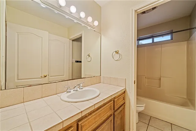 an empty room with a window and a ceiling fan