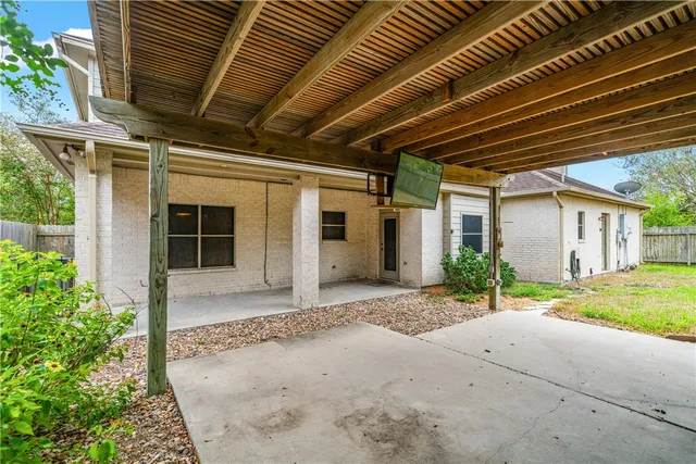 a view of a yard with plants and trees
