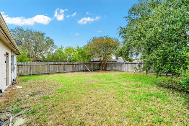 a backyard of a house with lots of green space