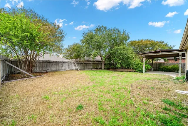 a front view of house with yard and trees