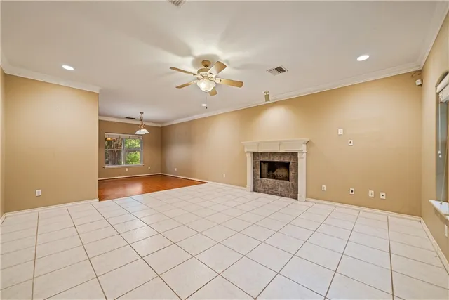 a view of an empty room and window chandelier fan