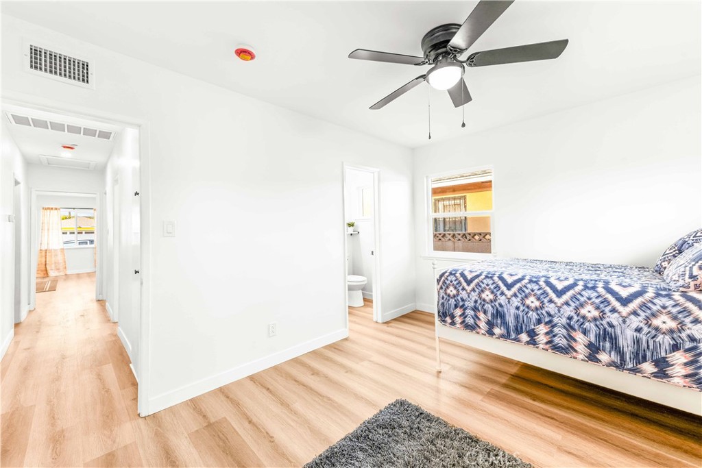 534 West 224th Place Carson, CA 90745 - Photo 26 of 35 a bedroom with a bed and a chandelier