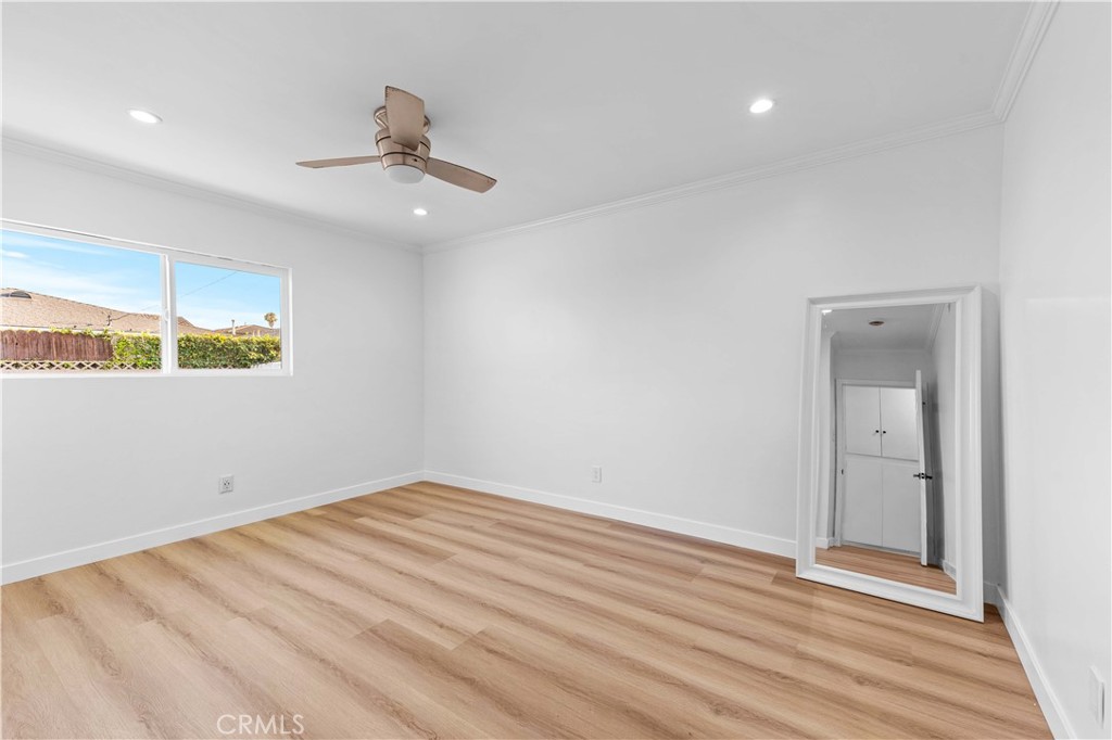 534 West 224th Place Carson, CA 90745 - Photo 30 of 35 an empty room with wooden floor ceiling fan and windows