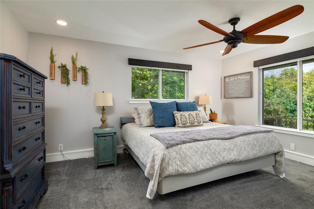 205 Timberlake Drive Azle, TX 76020 - Photo 17 of 40 a bedroom with a bed and a ceiling fan