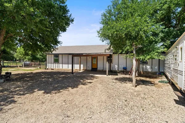 a house with trees in the background
