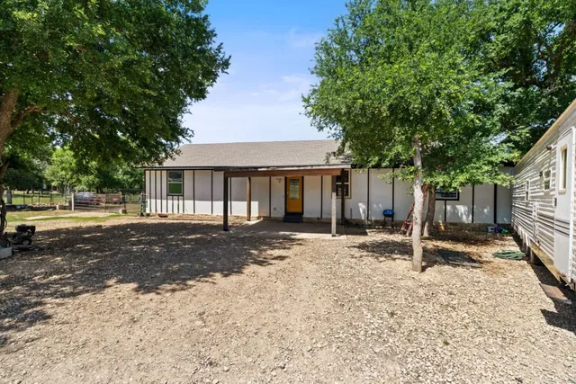 a house with trees in the background